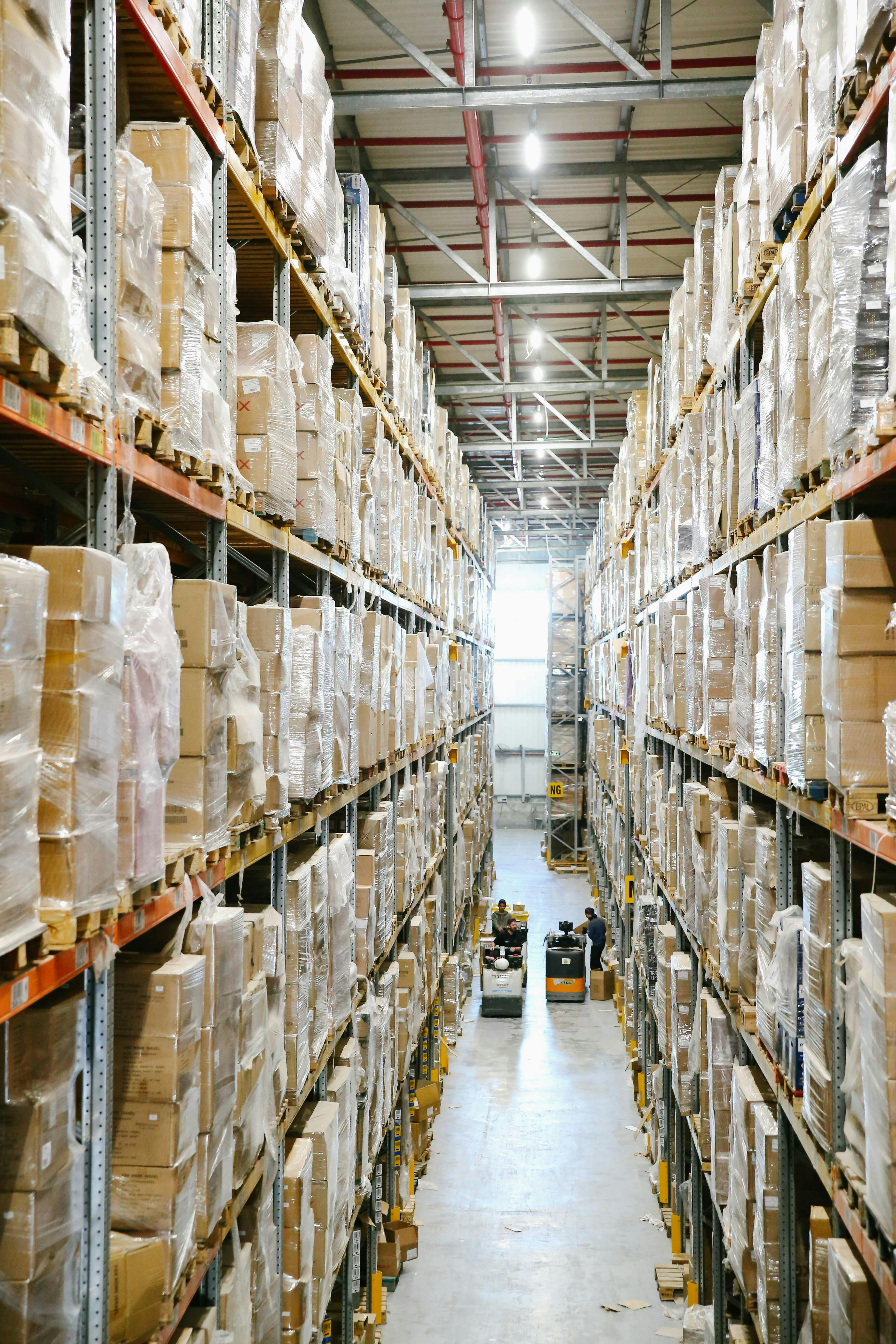 Vertical warehouse aisle with stacked product on industrial racking