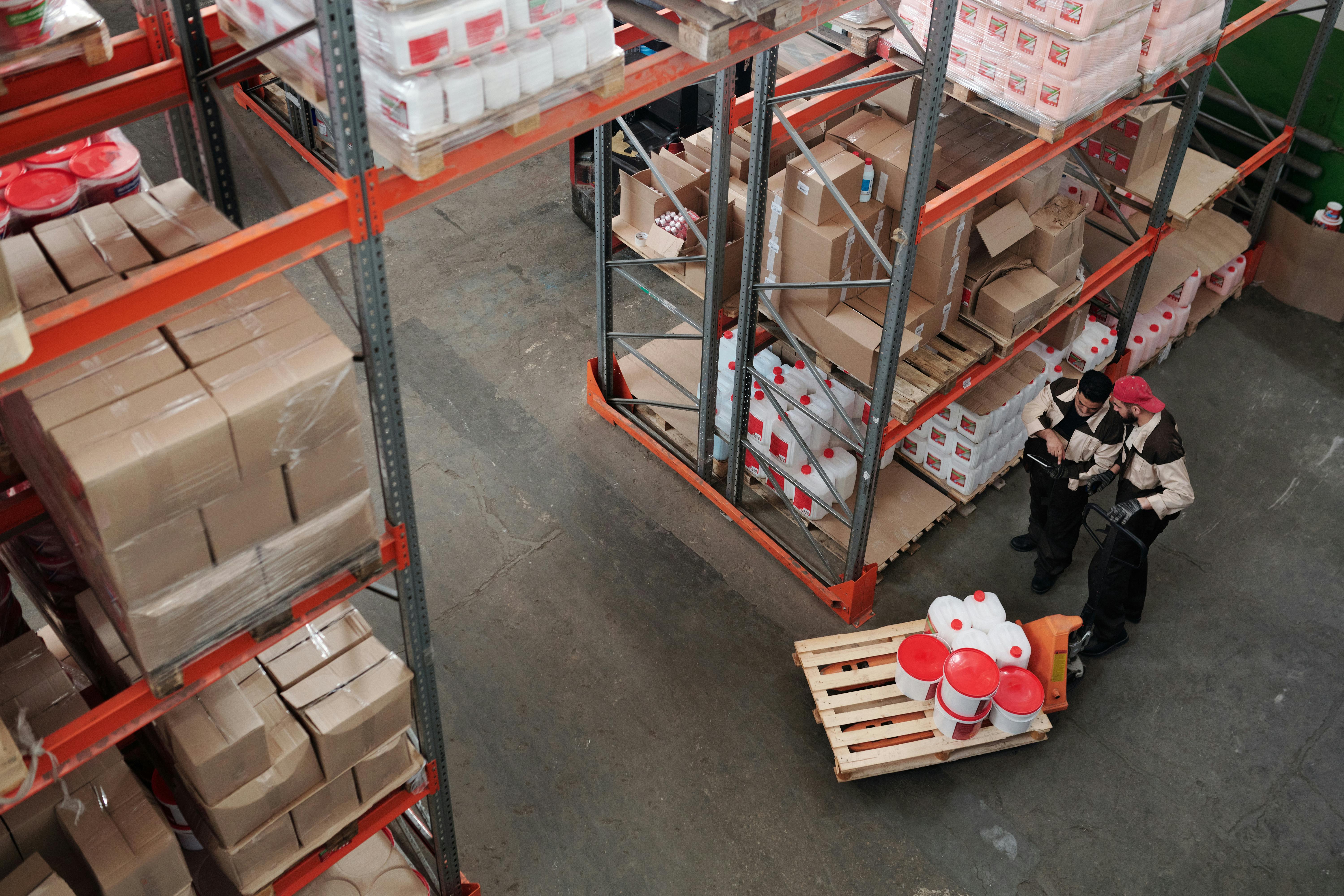 Operations team reviewing inventory at warehouse shelving